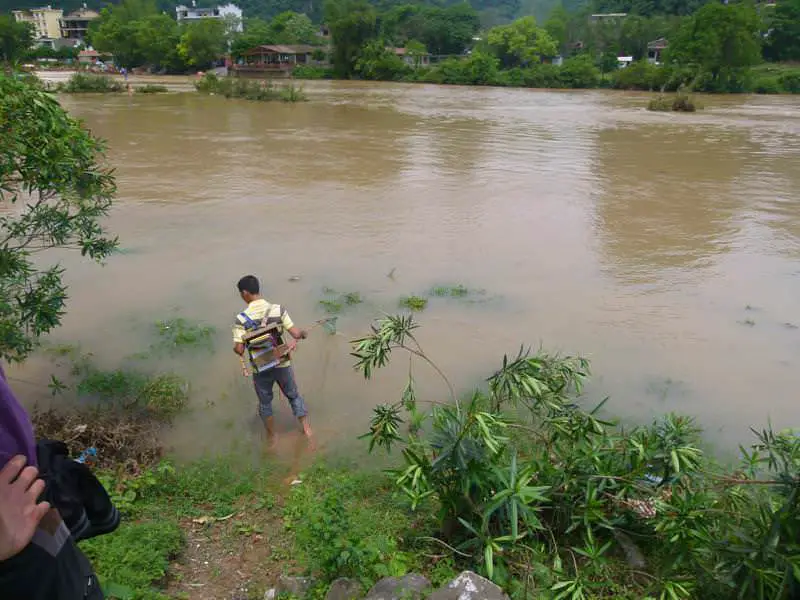 a man "fishing" in the river - using a car battery to fry the fish! Yangshuo - Nous sommes enfin en Chine ! - Yangshuo - Nous sommes enfin en Chine !